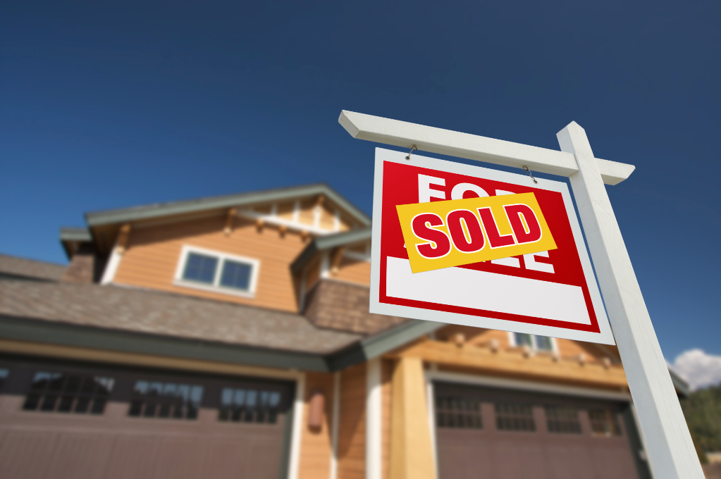 Sold Home For Sale Sign in Front of Beautiful New House